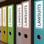 Many binders with LAWSUITS inscription. 3D rendering