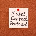 "Model Context Protocol" handwritten on a post-it note, stuck on a bulletin board