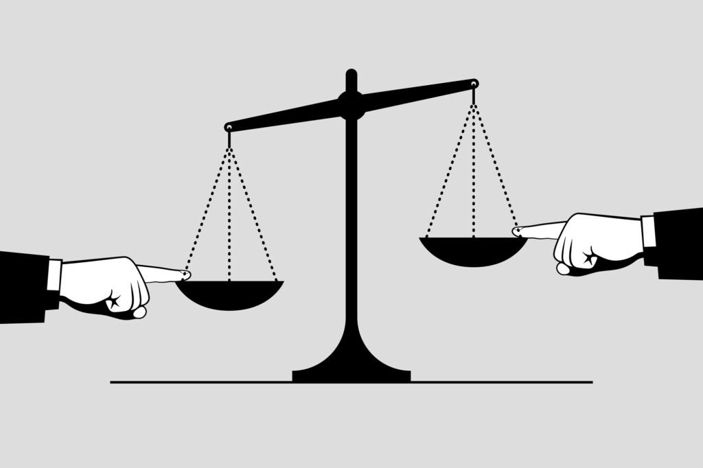 Scales and hands touching the bowls with index fingers from opposite sides. Arguments, evidence and tricks in trial. Concept of judging, trial and justice