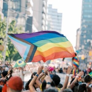 Toronto Canada pride parade includes a crowd waving pride flags